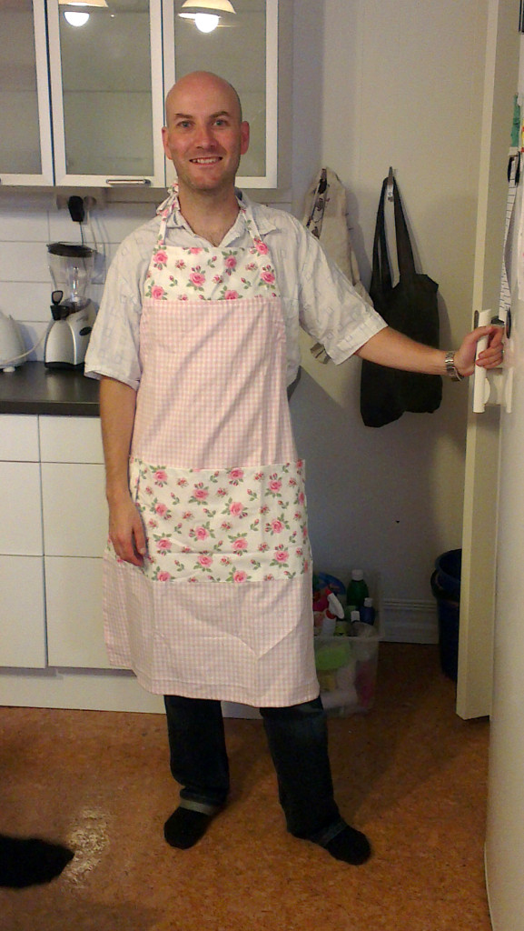 Ryan Hellyer wearing a lovely pink apron