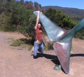 Vicky Argyle hanging from a whale fin