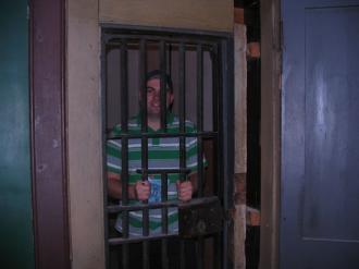 Jon Kitchen looking oddly at home inside a locked prison cell
